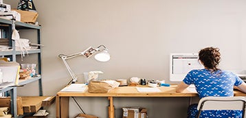 Lady sitting by desktop working