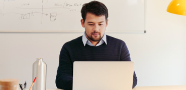 photo of someone watching video on their laptop