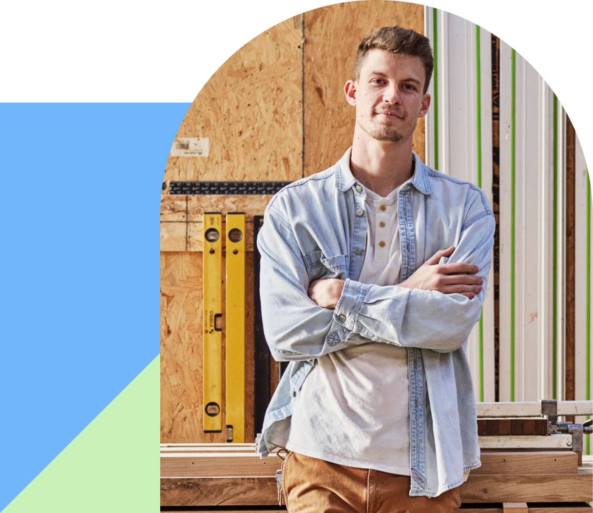 man smiling with arms crossed