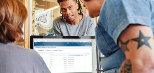 3 people looking at a computer